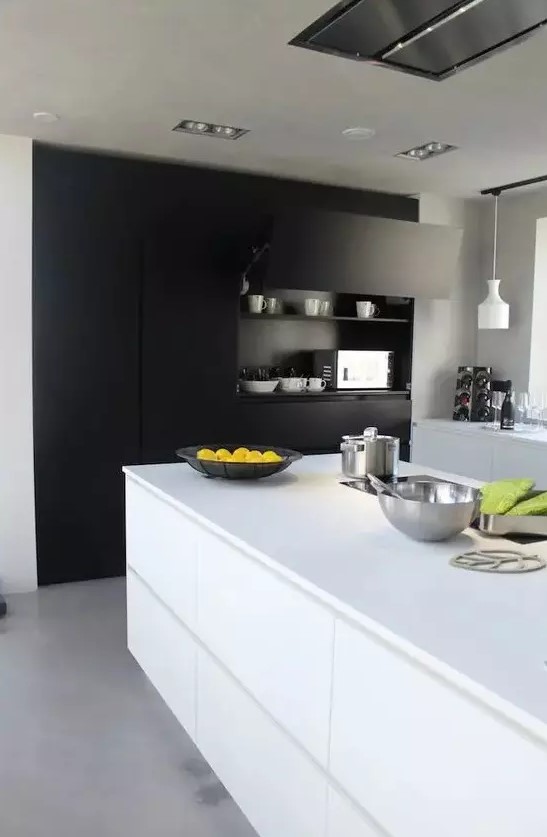 a modern black and white kitchen with built-in matte storage, sleek white cabinets and a kitchen island, pendant lamps and plenty of natural light