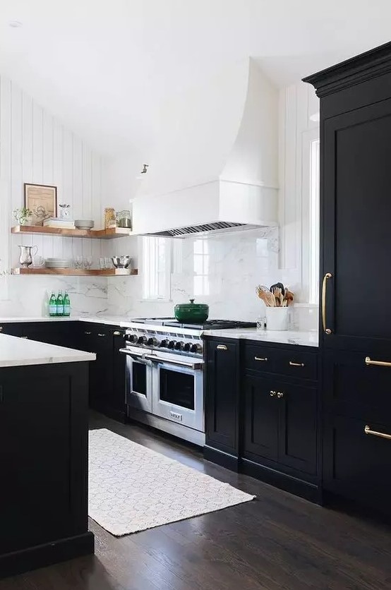 A modern black and white farmhouse kitchen with shaker cabinets, white marble countertops, open shelving, a white range hood and a white marble backsplash