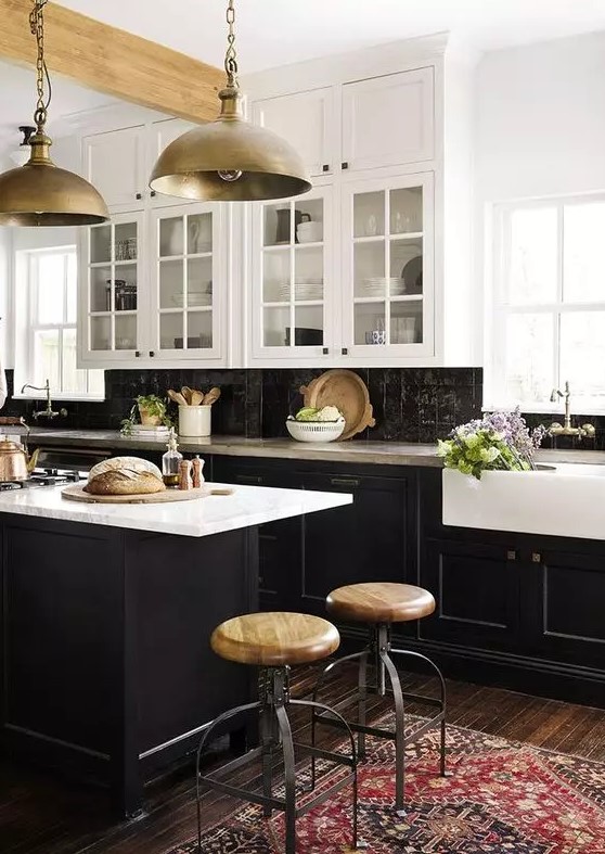 a vintage-inspired kitchen with black shaker cabinets, white countertops and a black zellige tile backsplash, and metal pendant lamps
