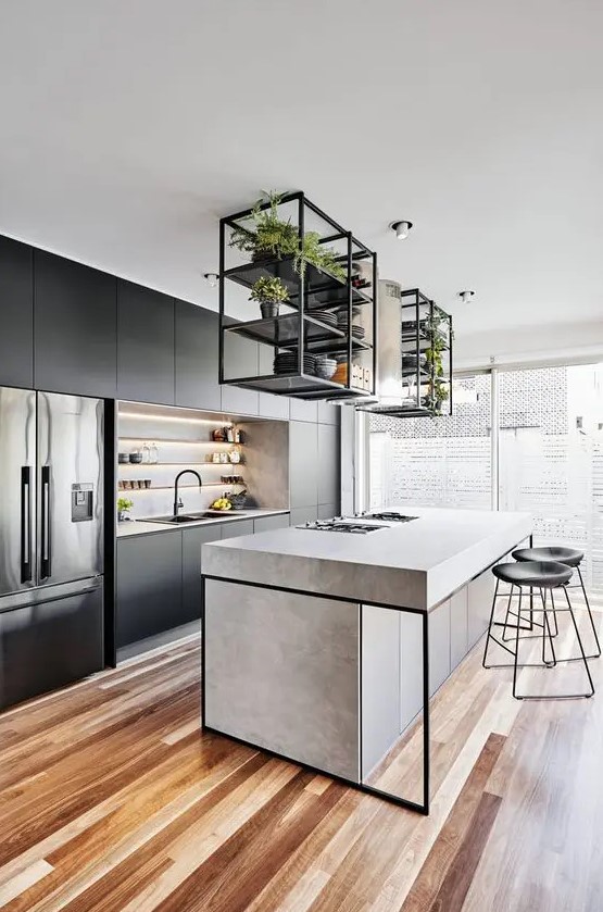 a modern kitchen with sleek black cabinets, a concrete kitchen island, black frame, black stools and built-in lamps