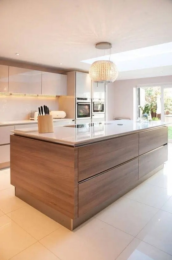 a modern kitchen with sleek white cabinets and a richly stained kitchen island, sleek white countertop and backsplash
