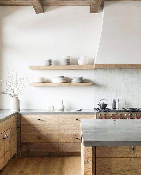 a calm, modern kitchen with white walls, wood and concrete cabinets and a white tile backsplash