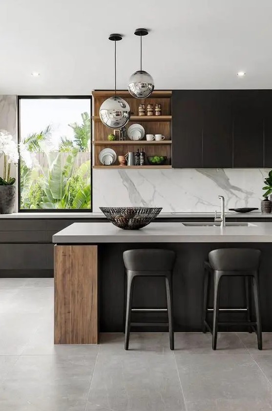 A highly sophisticated modern kitchen with sleek black cabinets, stained wood units, white stone worktops and a splashback