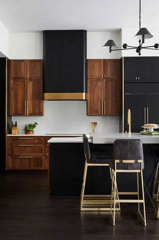 a dramatic two-tone kitchen with richly stained cabinets, black, white stone countertops and a white backsplash, touches of gold here and there