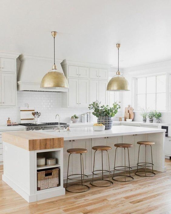 a white farmhouse kitchen with shaker-style cabinets, white stone countertops, a white subway tile backsplash, and an island with open storage nooks
