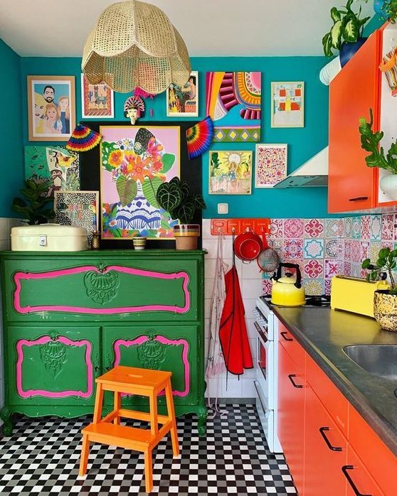 a stylish kitchen with a colorful gallery wall