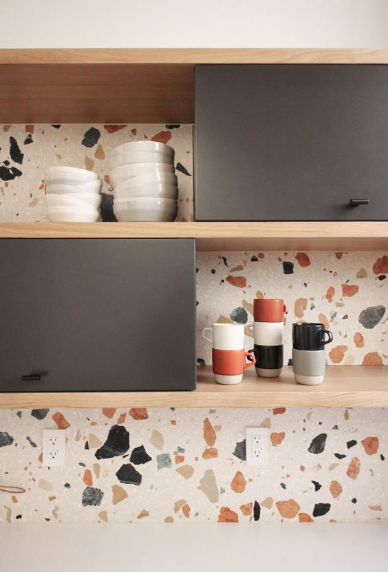 An eye-catching closed and open kitchen cabinet with a bright terrazzo backsplash that adds accessibility and interest to the room