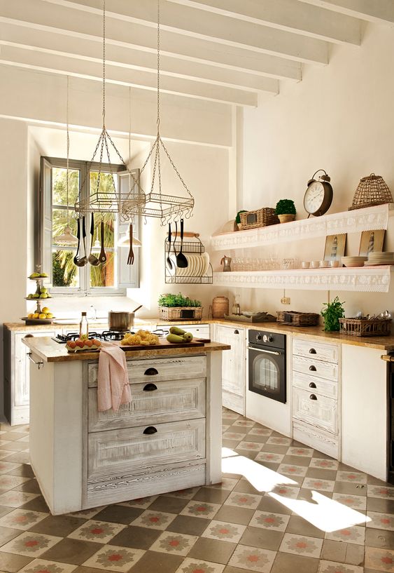 a neutral shabby chic kitchen with butcher block countertops and a matching kitchen island with drawers for storage