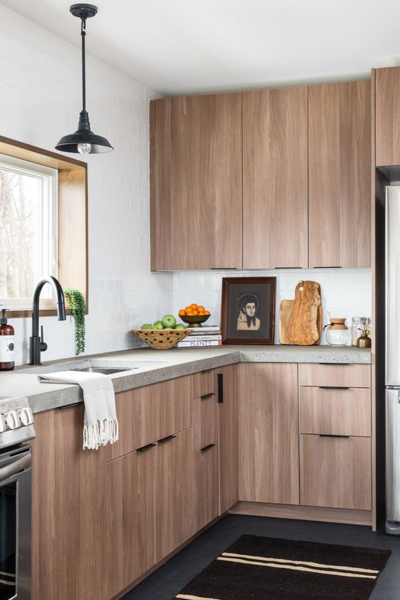 a modern wooden kitchen with a concrete worktop