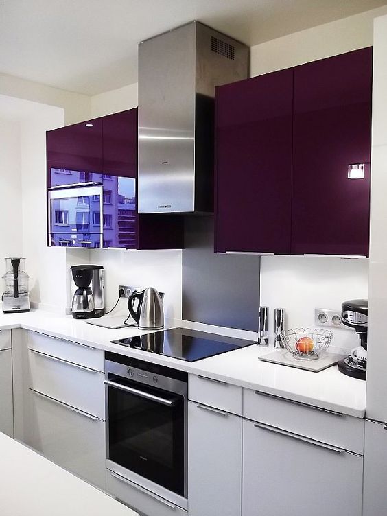 A chic modern kitchen in deep purple and gray with a white backsplash and worktop looks stunning