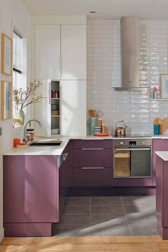 a stylish modern kitchen with white and purple cabinets, glossy white thin tiles and stainless steel appliances