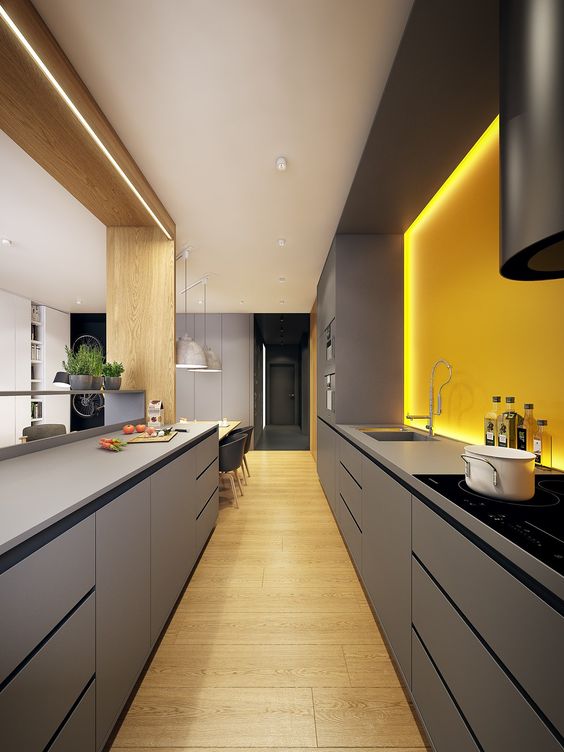 A bold, minimalist kitchen with sleek gray cabinets and a sunny yellow-lit backsplash for a bright look