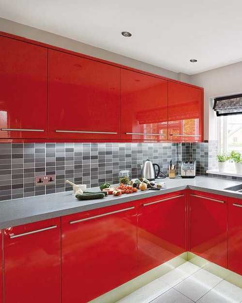 A bright red modern kitchen with a concrete countertop and a pretty gray tile backsplash is a bold and cool solution