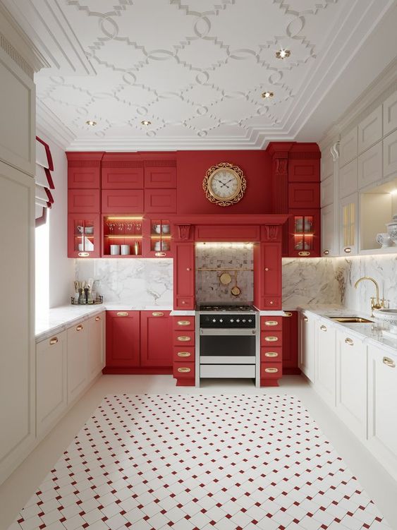 A sophisticated kitchen with white and red cabinets, white marble countertops and gold handles, and a tile floor is simply impressive