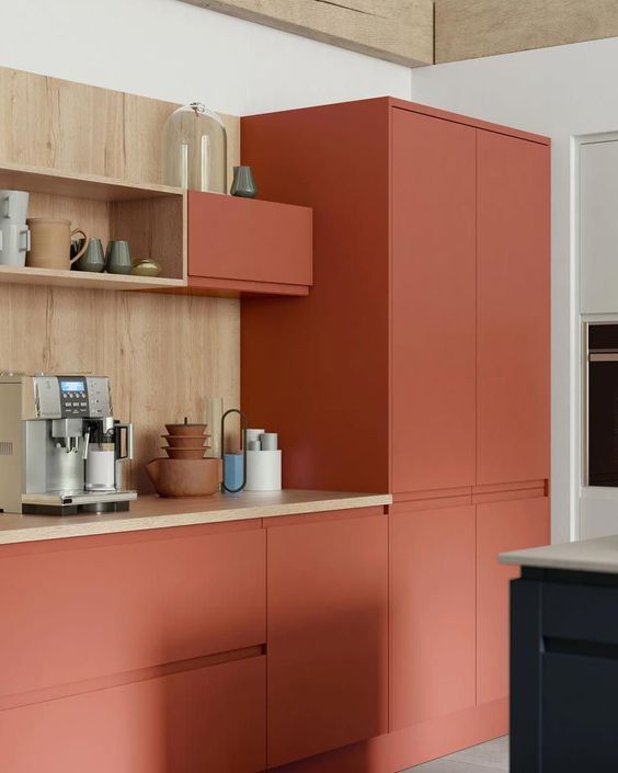 A minimalist terracotta kitchen with wooden countertops and a backsplash looks bold and very eye-catching