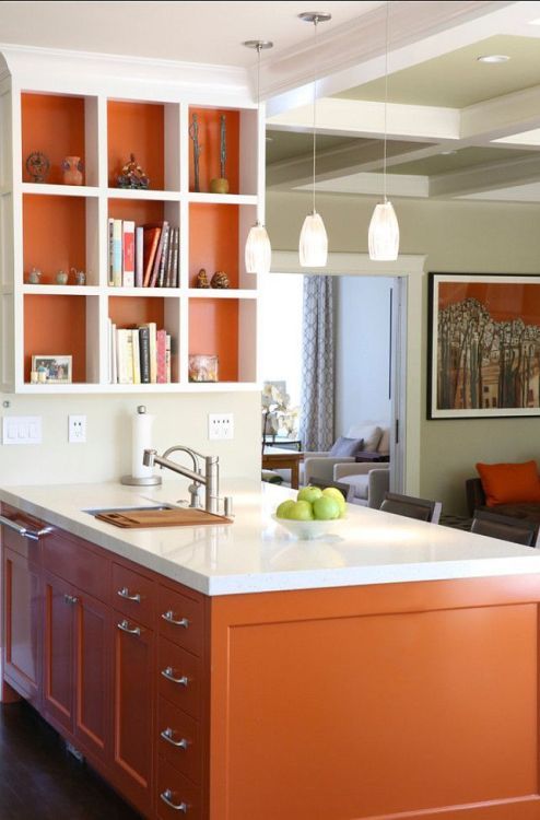 a modern burnt orange kitchen with white stone countertops and matching open shelving and pendant lamps