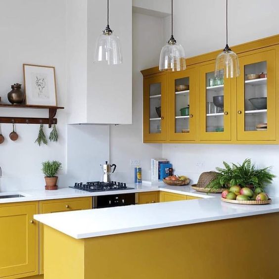 A chic, modern kitchen in mustard yellow with everything white is a bold and stylish option