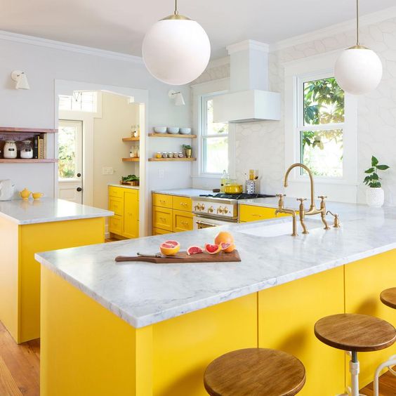 A chic farmhouse kitchen with sunny yellow cabinets and all neutral tones feels airy and bright