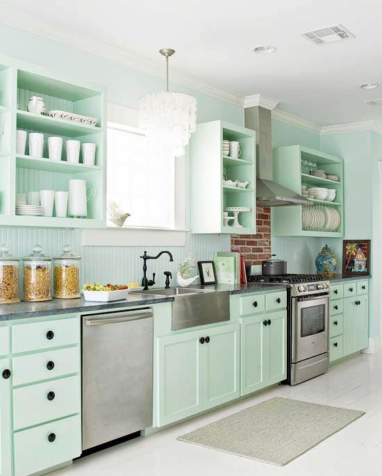 A fresh and beautiful mint green kitchen with black knobs, faucets and lots of white to make it seem more ethereal