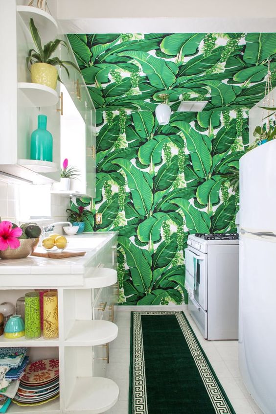 elegant white cabinets with a banana leaf print that takes up the entire room and an emerald green rug