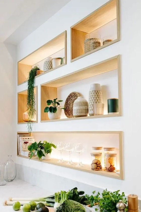 Cool niche shelves with stained wooden frames and lights show off your things to their best advantage