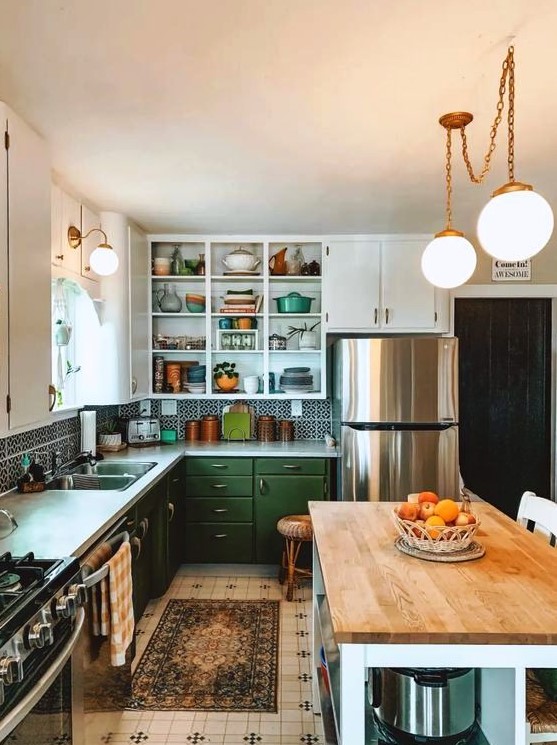 a 1950s farmhouse kitchen with white and green cabinets, a printed tile backsplash and rug, a kitchen island with butcher block countertops