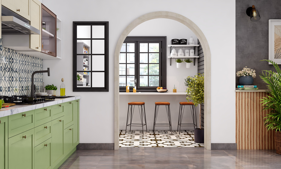 The design of the kitchen entrance arch serves as a subtle partition between the dining area and the kitchen
