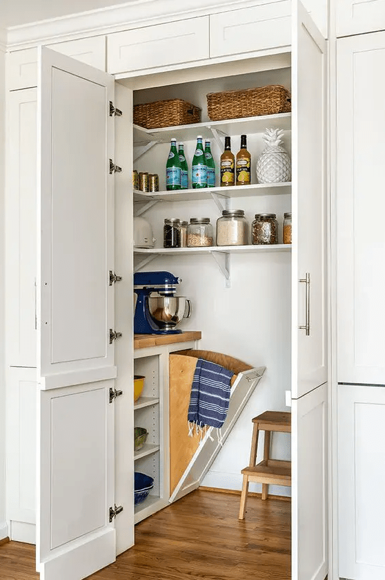 a cool little pantry with corner shelves, built-in open storage, a stool, and some cookware and appliances