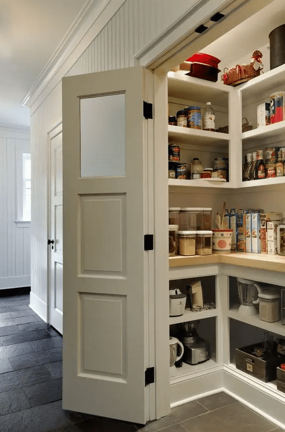 a small and cool pantry with built-in storage units and shelves, cookware, appliances, food and beverages and plenty of light