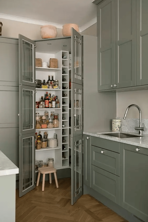 A small pantry that fits perfectly into the kitchen, with built-in shelves and wine storage, and a small stool is a smart idea