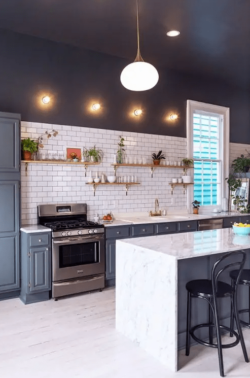 a contrasting kitchen with dark walls, a white subway tile backsplash, gray cabinets and open shelving, and lights