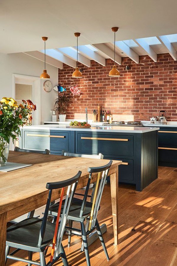 Brick kitchen back wall with dining area