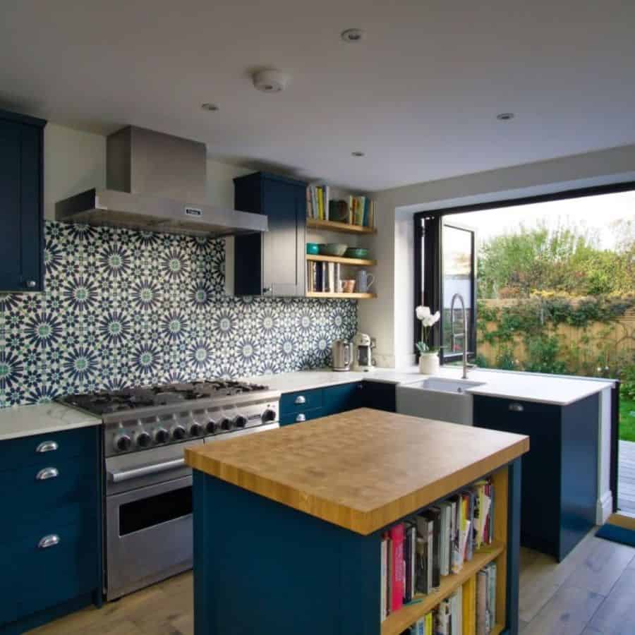 Blue cabinet kitchen with butcher block work island 