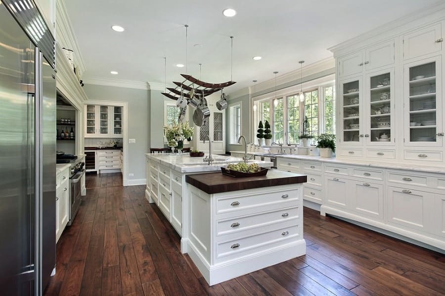 Large, white, country-style kitchen with island 