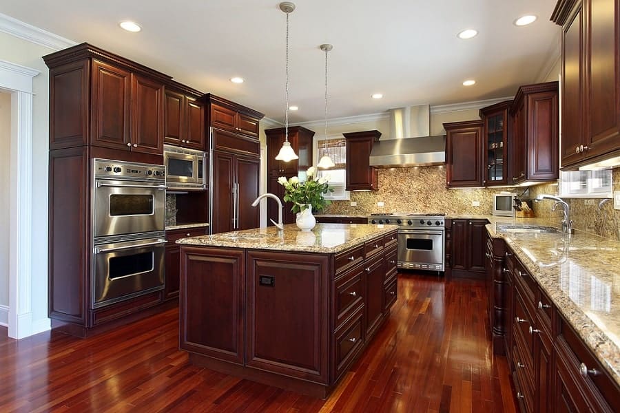 large wooden kitchen with granite countertops and island 