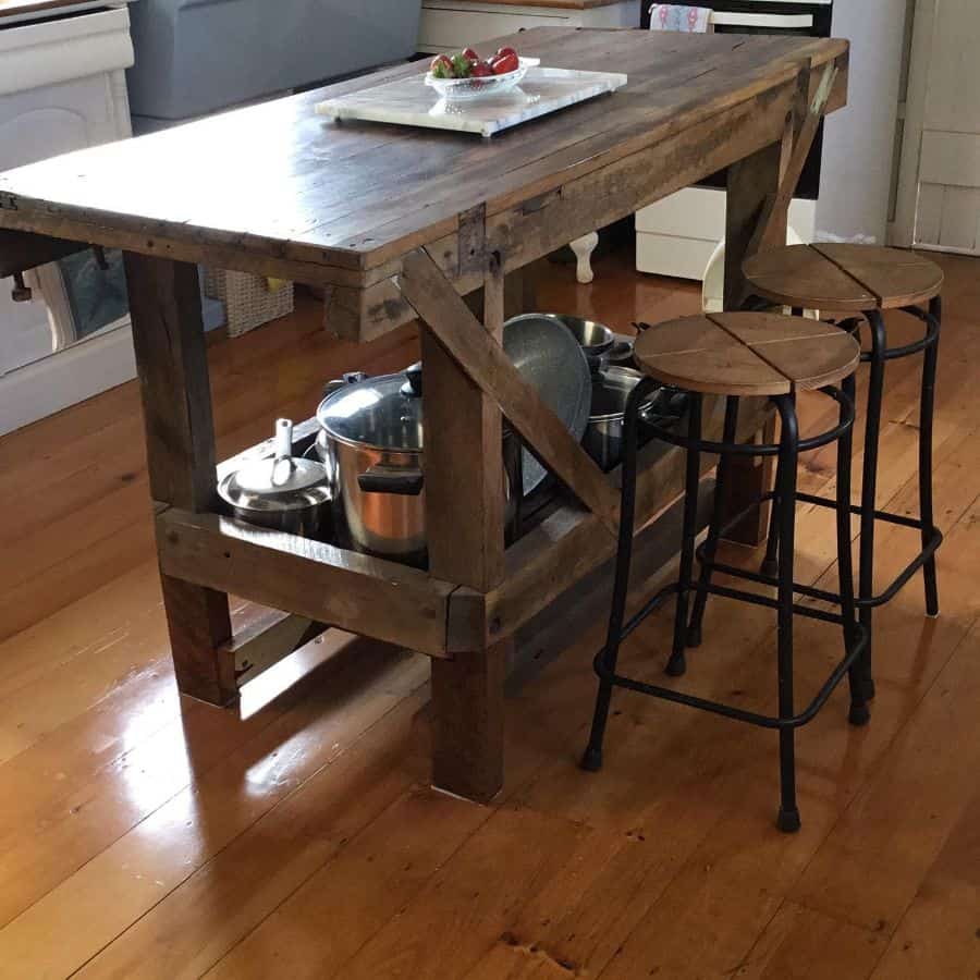 Rustic wooden table island in the farmhouse kitchen 
