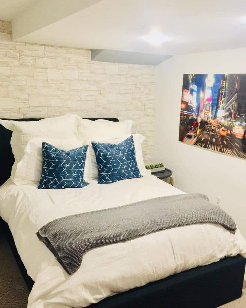 White brick wall, small basement bedroom 