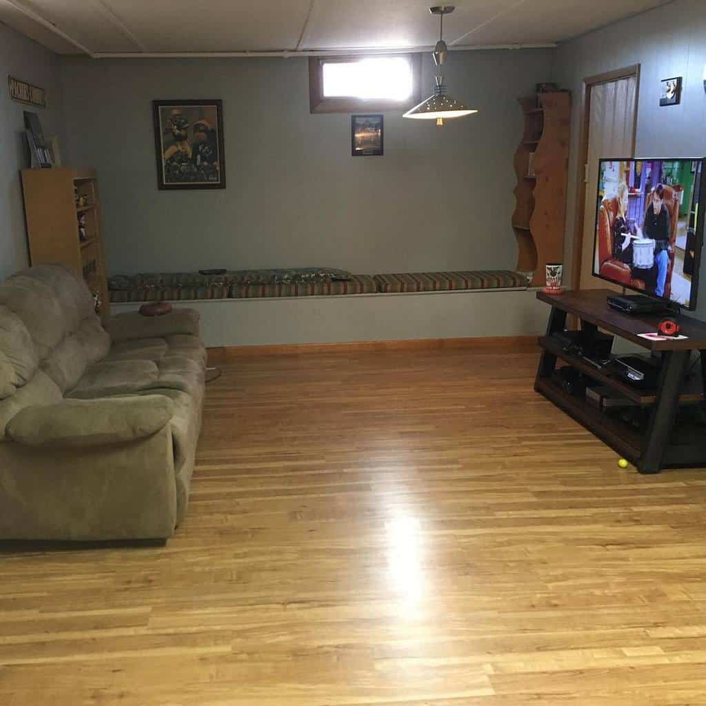 small living room in the basement with bench and sofa 
