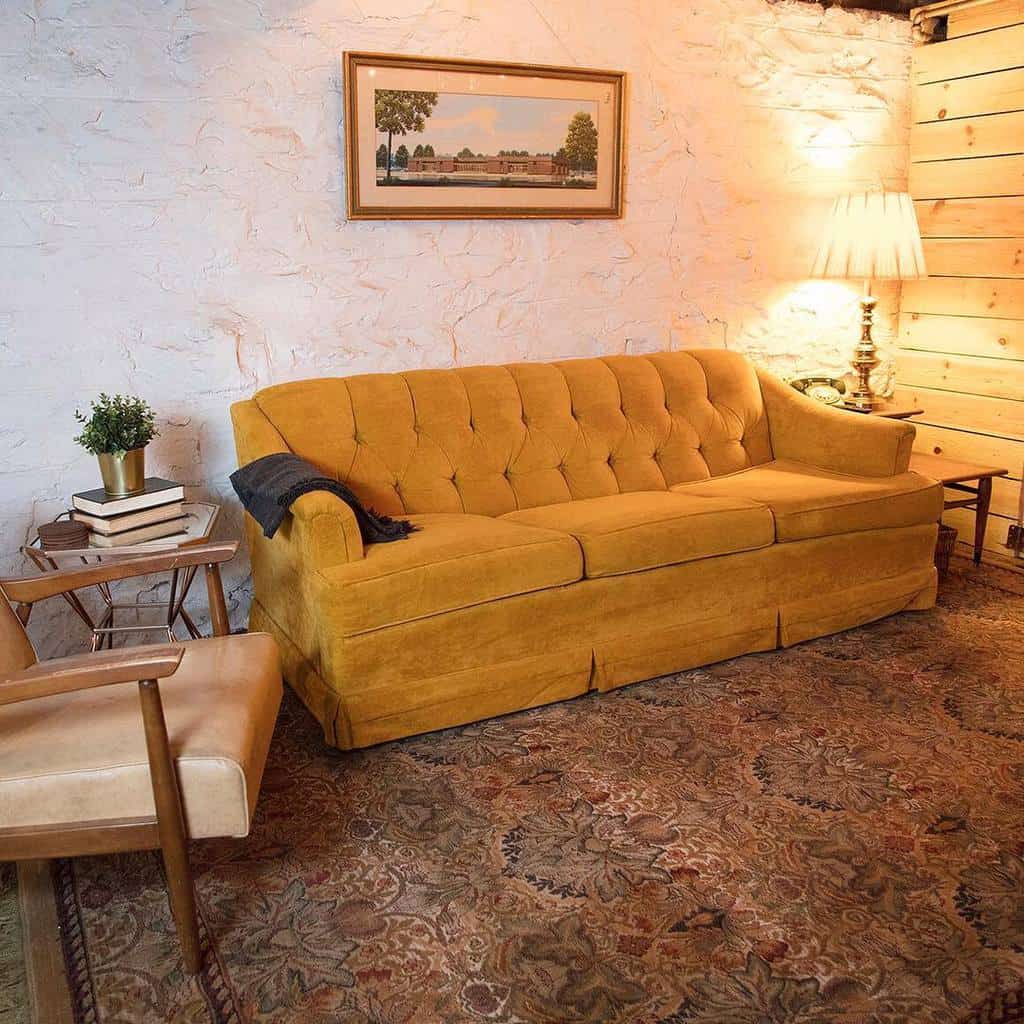 Rustic basement living room with mustard colored sofa