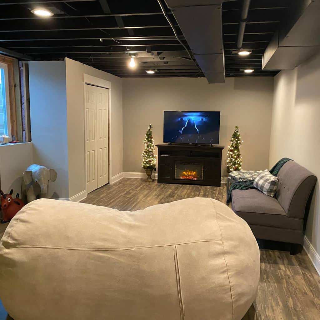 small living room in the basement with exposed ceiling 