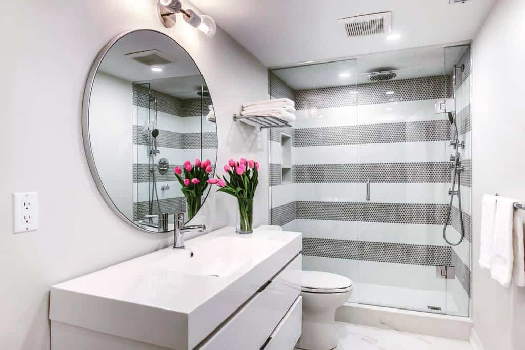 Modern small bathroom in the basement with mosaic tile shower 