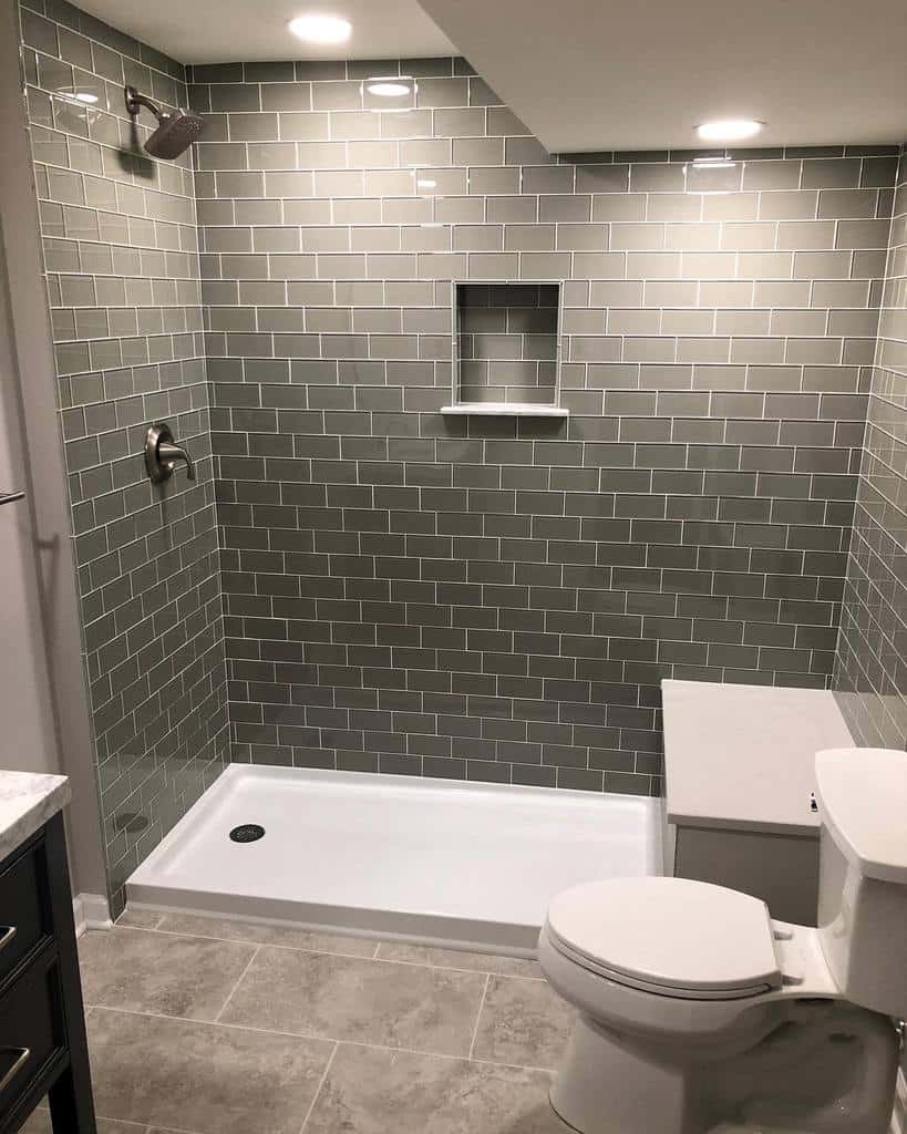 Large gray tiled shower in renovated bathroom 