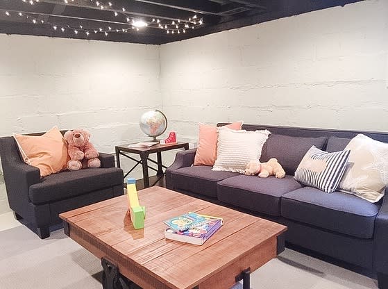 Small living room in the basement with sofa and wooden coffee table 