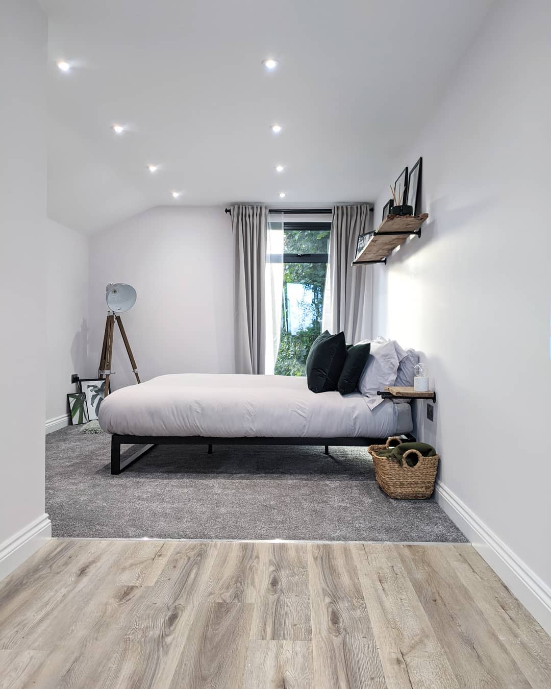 small bedroom, garage, wooden wall shelf, wicker laundry basket, gray carpet 