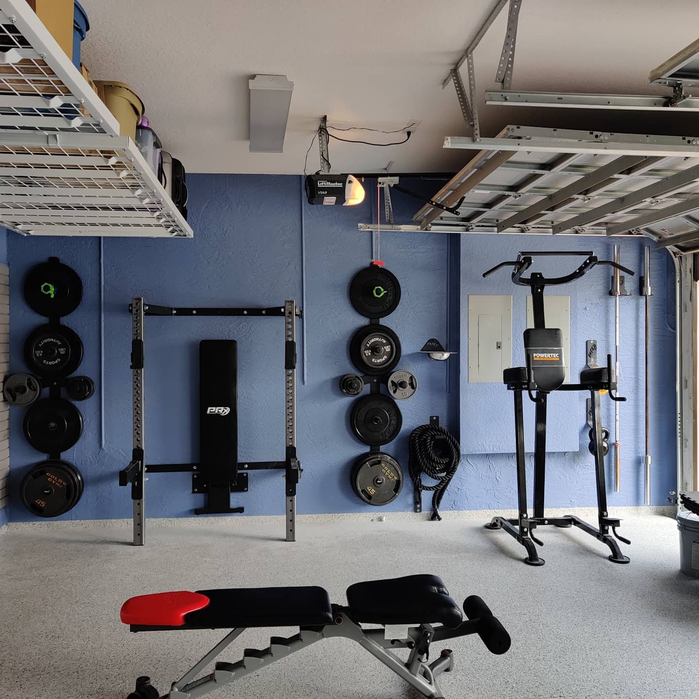 Garage, gym, concrete floor, heavy weights, bench press