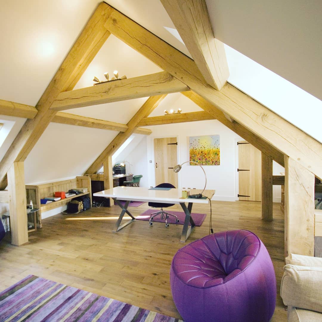 exposed ceiling, wooden beams, loft, white desk, purple accent chair 