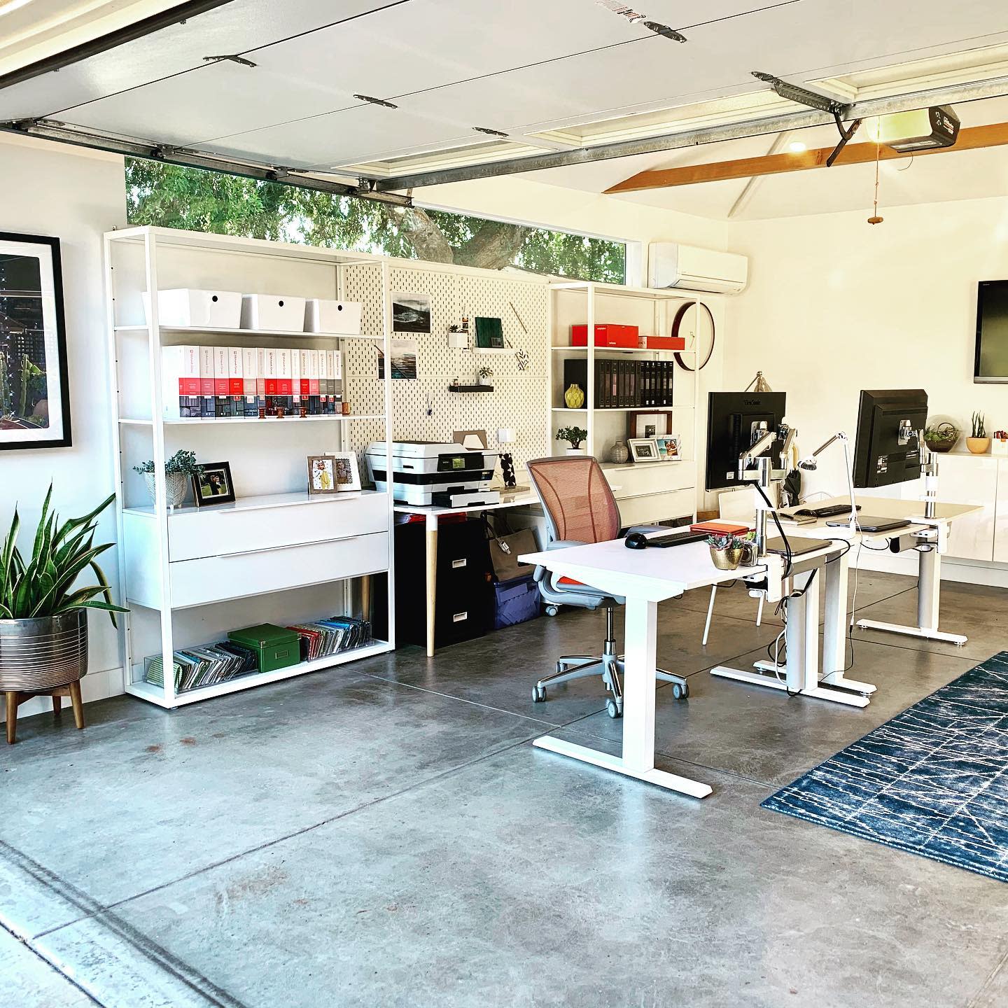 Office garage conversion, concrete floor, white office tables 