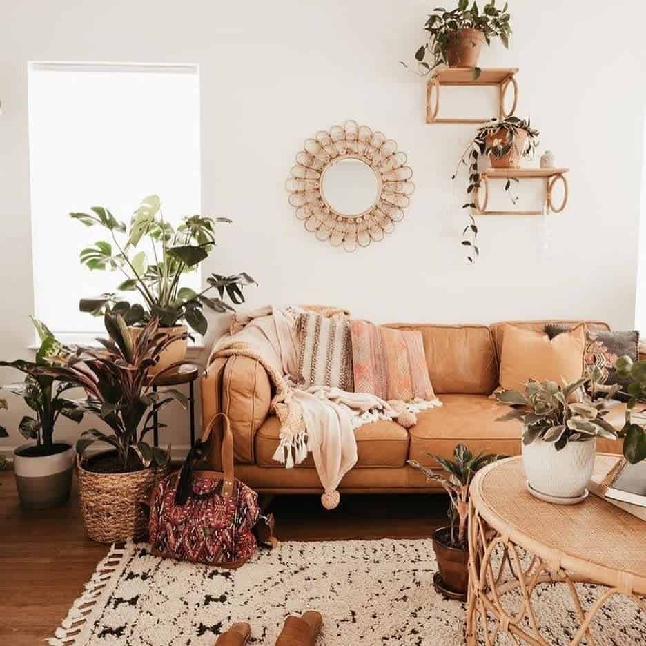 Rustic boho living room with brown leather sofa plants 