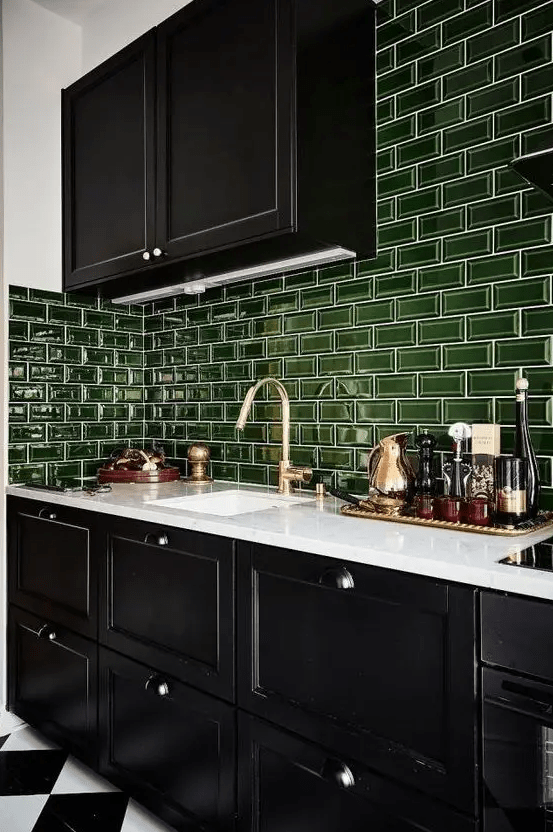 A bold black and white kitchen with glossy green subway tiles for a pop of color is very cool