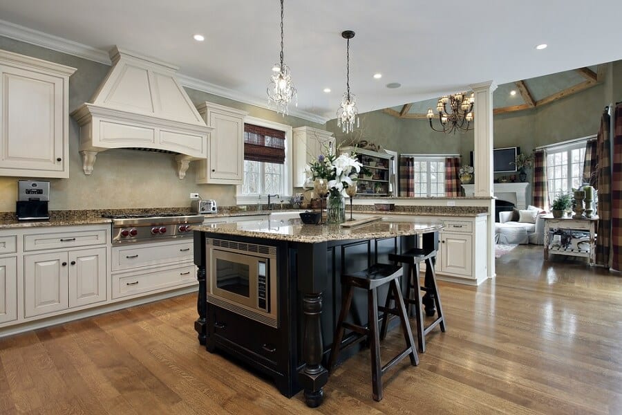 Large farmhouse kitchen with black wooden island 